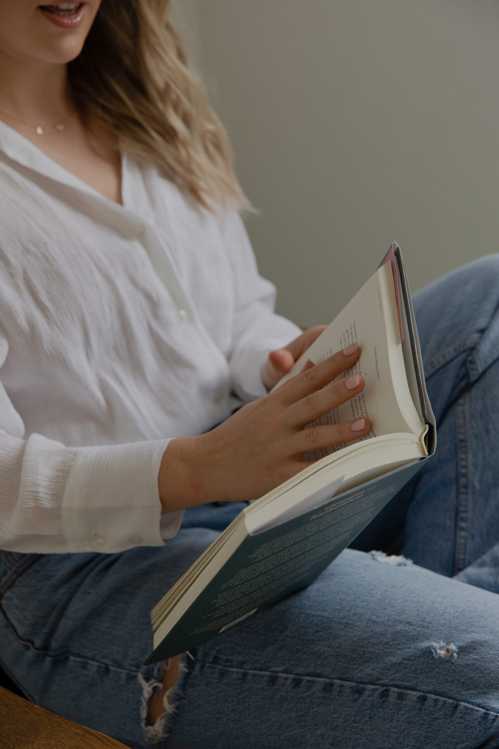 Website copywriter reading a book and sharing how connection builds conversions in your business