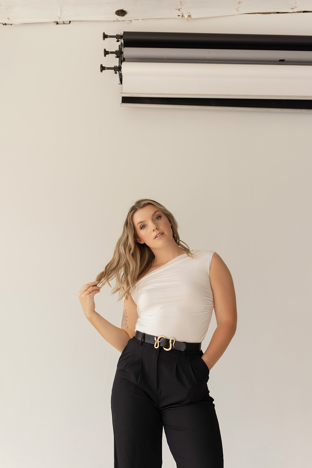kaili copywriter sharing the levers of selling while standing in front of a white backdrop