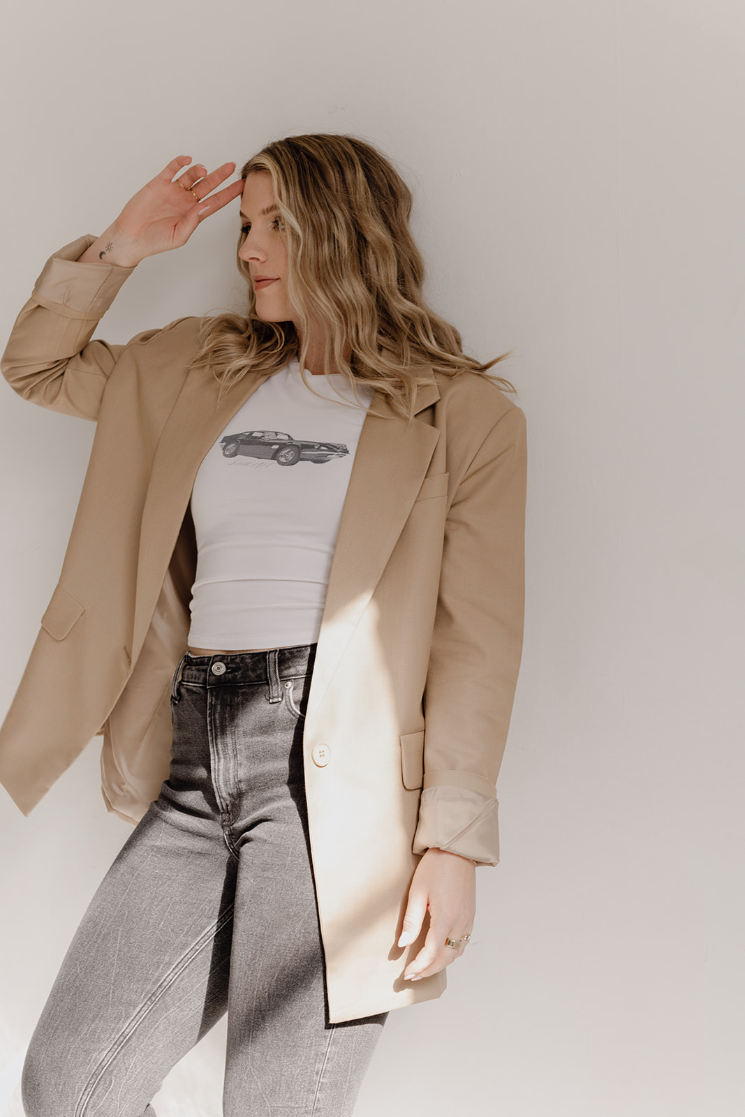 Kaili, conversion copywriter standing in front of a white wall wearing casual clothes